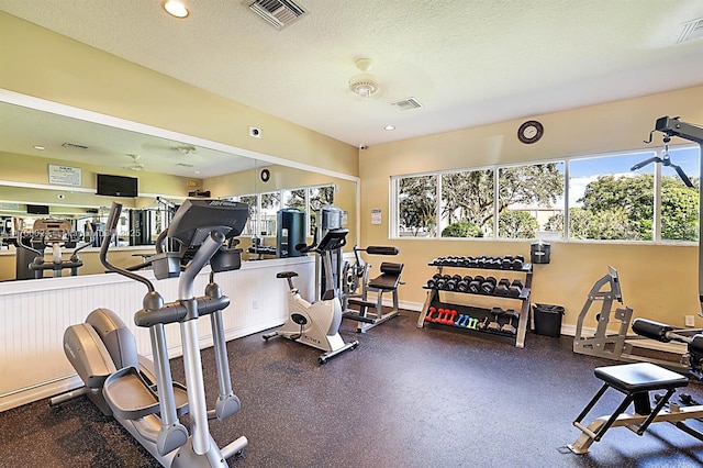 gym featuring a textured ceiling