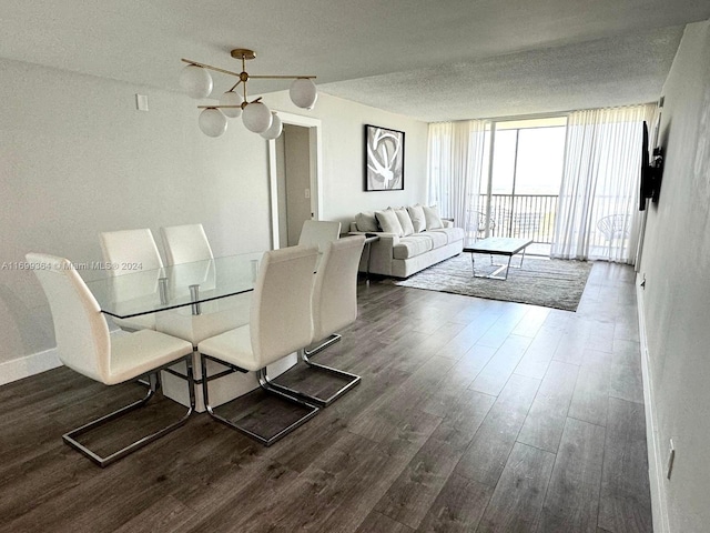 unfurnished dining area with dark hardwood / wood-style flooring, expansive windows, a textured ceiling, and an inviting chandelier