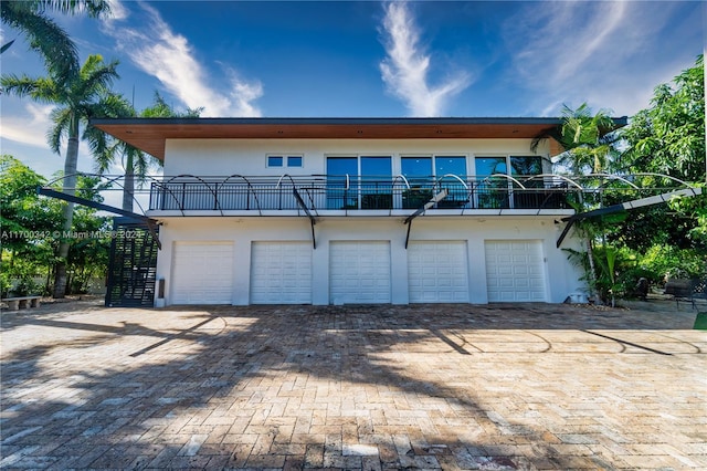 exterior space featuring a balcony and a garage