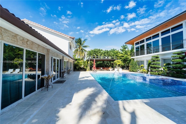 view of pool featuring pool water feature and a patio