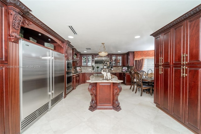 kitchen with a kitchen bar, decorative backsplash, stainless steel appliances, pendant lighting, and a center island