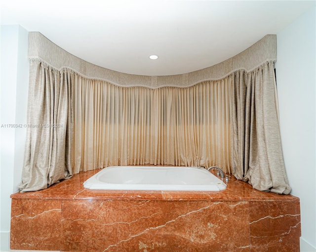 bathroom with tiled tub