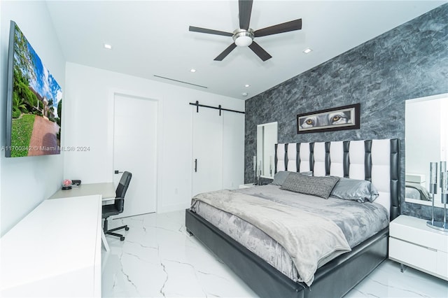 bedroom featuring ceiling fan and a barn door