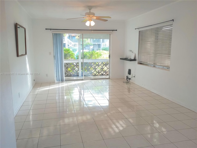 empty room featuring ceiling fan and light tile patterned floors