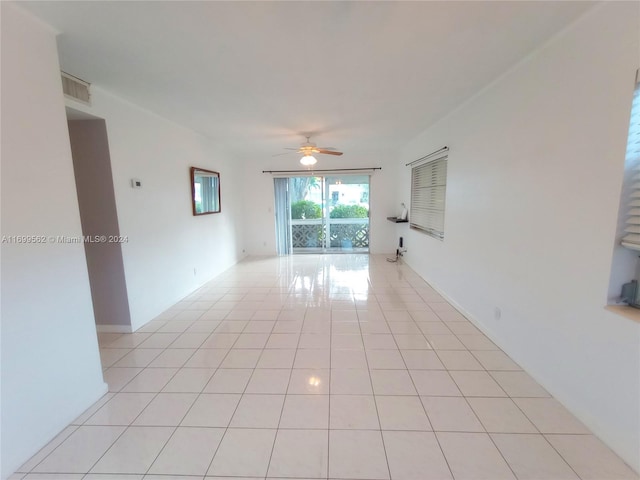 spare room with ceiling fan and light tile patterned floors