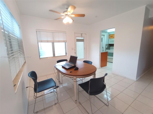 tiled dining room featuring ceiling fan