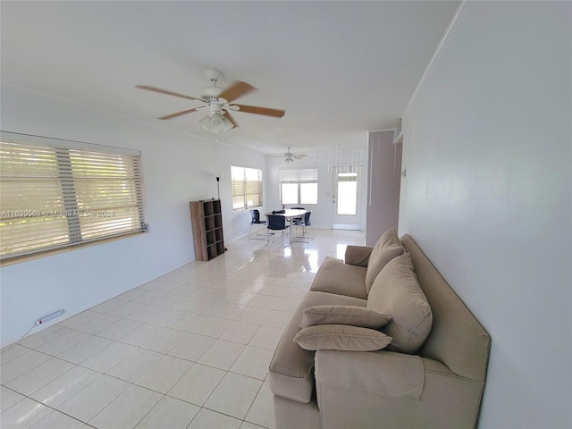 living room featuring ceiling fan and light tile patterned floors