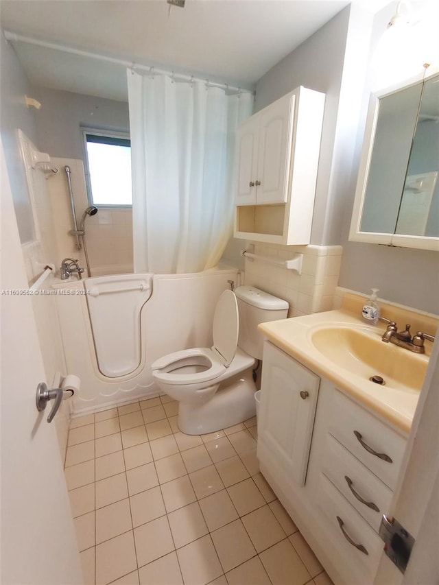 full bathroom featuring tile patterned flooring, vanity, toilet, and shower / tub combination