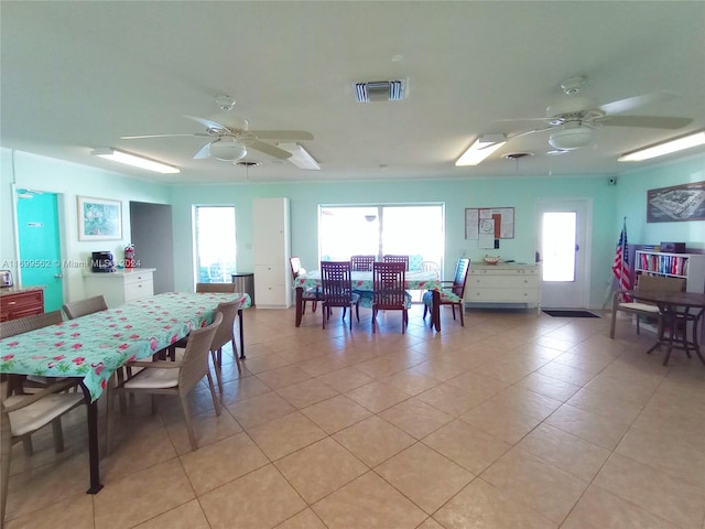 dining space with ceiling fan and light tile patterned floors