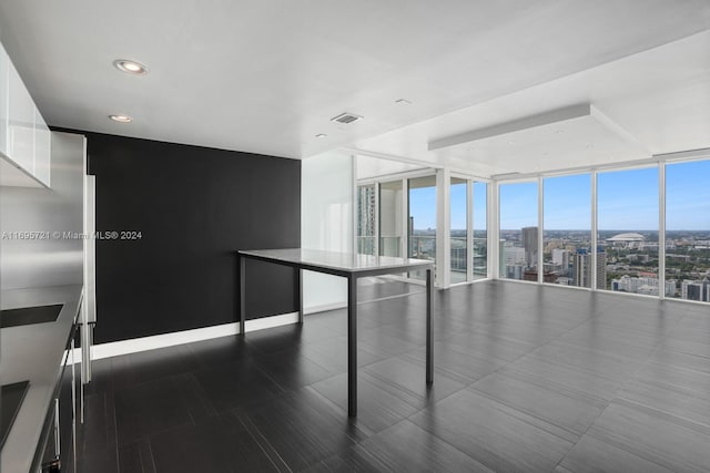 empty room featuring a wall of windows