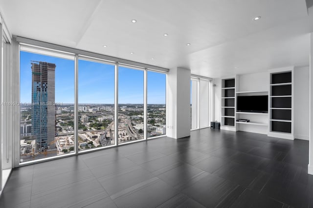 unfurnished living room with floor to ceiling windows and plenty of natural light