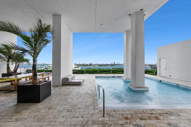 view of swimming pool featuring a water view