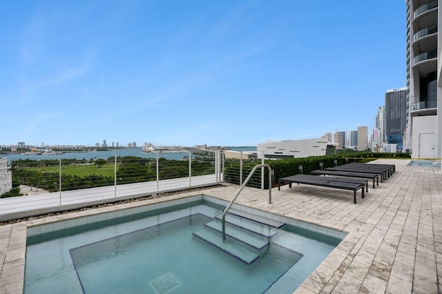 view of swimming pool featuring a hot tub