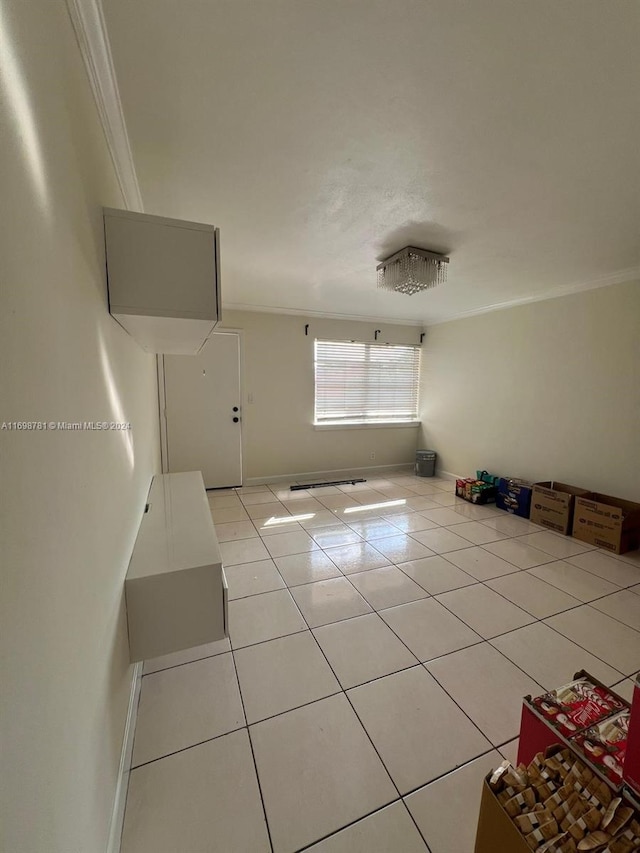 unfurnished living room featuring light tile patterned floors and ornamental molding