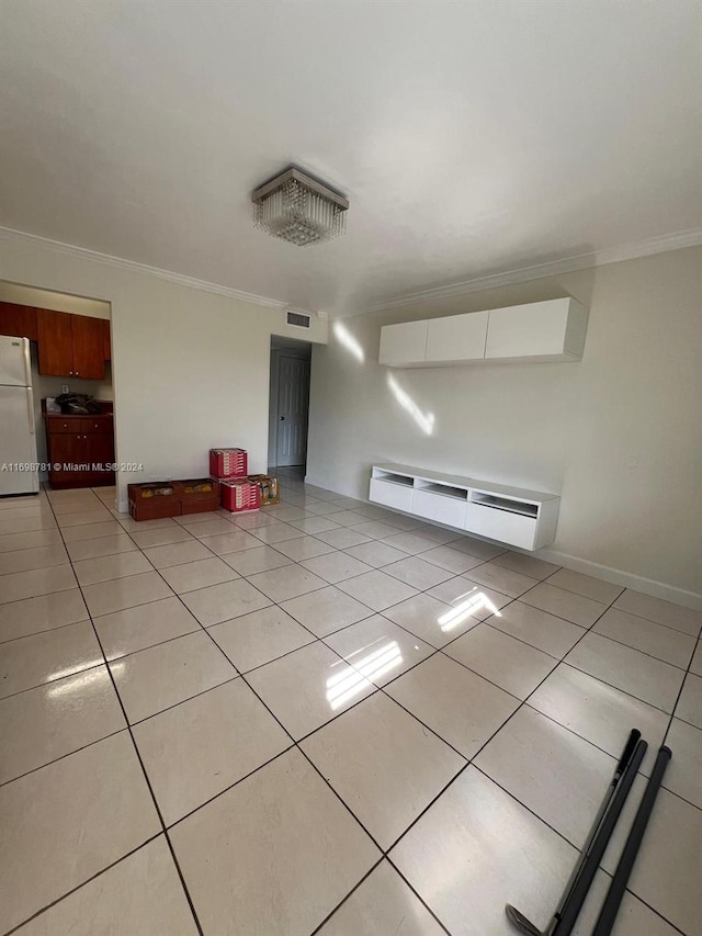 tiled empty room with ornamental molding and baseboard heating