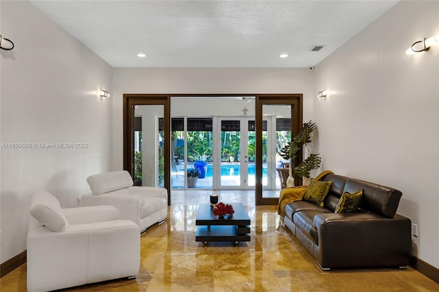 living room featuring french doors and a textured ceiling