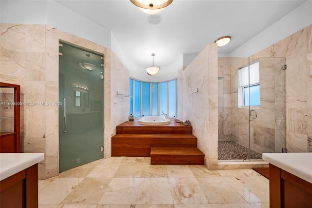 bathroom featuring vanity and shower with separate bathtub