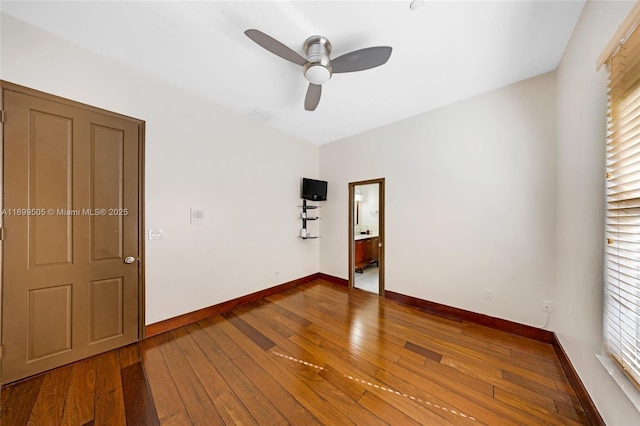 unfurnished room with ceiling fan, a healthy amount of sunlight, and hardwood / wood-style floors