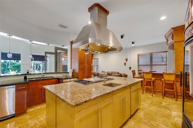 kitchen featuring a center island with sink, island range hood, stainless steel appliances, and dark stone countertops