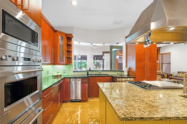 kitchen with tasteful backsplash, light stone countertops, island exhaust hood, and stainless steel appliances