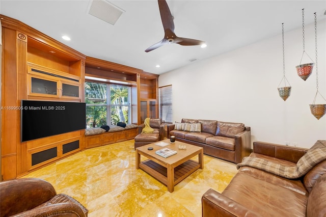 living room with ceiling fan and built in shelves