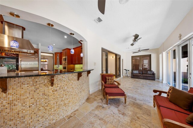 welcome area featuring ceiling fan and french doors