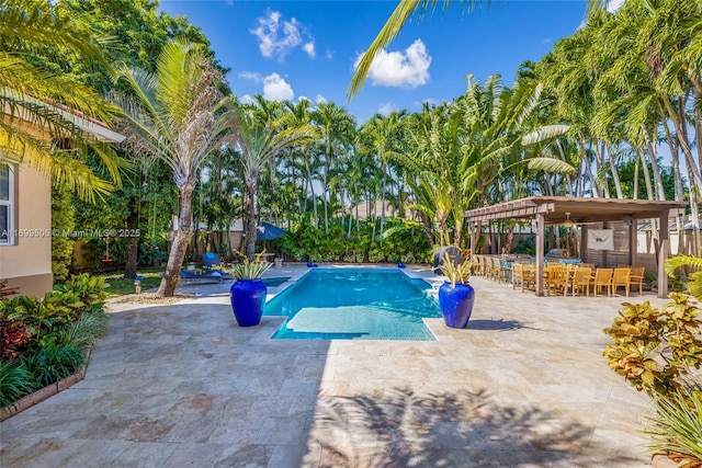 view of swimming pool with a gazebo, an outdoor bar, and a patio