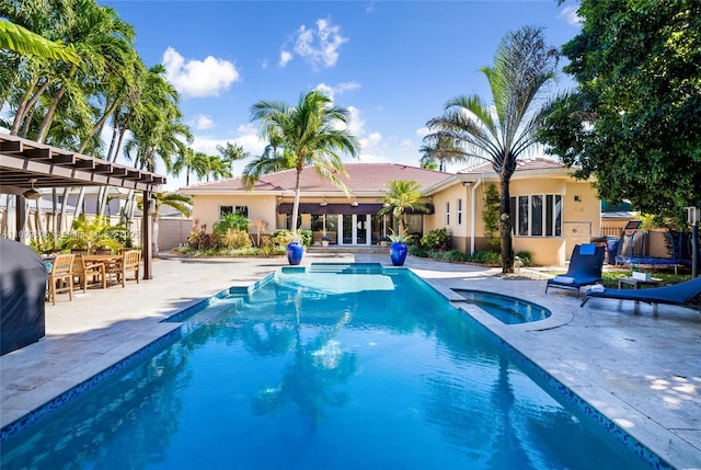 view of pool featuring a pergola, an in ground hot tub, and a patio