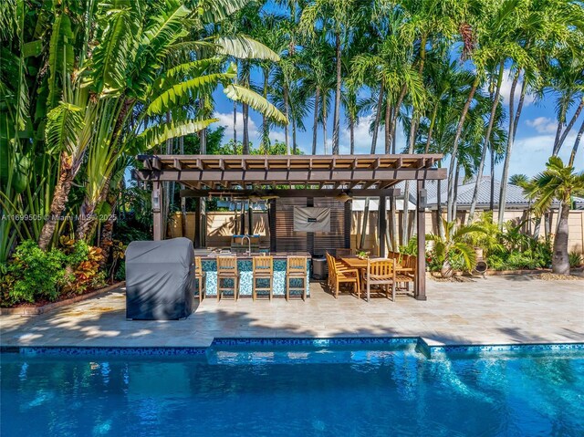 view of pool with a pergola, a patio area, and an outdoor bar