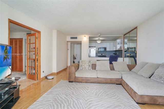 living room with hardwood / wood-style flooring and a textured ceiling