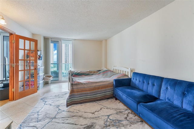 bedroom featuring light tile patterned flooring and a textured ceiling