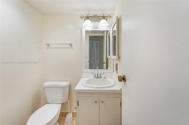 bathroom featuring tile patterned floors, vanity, and toilet