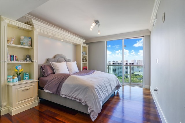 bedroom featuring access to outside, dark hardwood / wood-style flooring, and ornamental molding