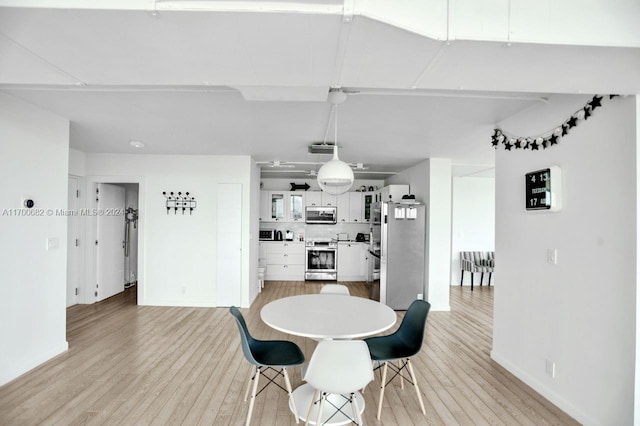 dining space with light hardwood / wood-style flooring