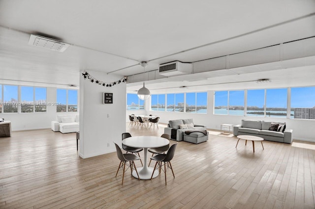 dining room featuring hardwood / wood-style floors and a water view