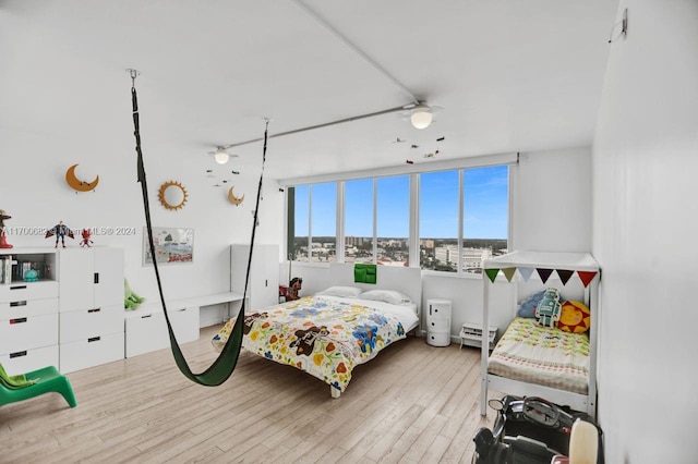 bedroom featuring ceiling fan and light hardwood / wood-style flooring