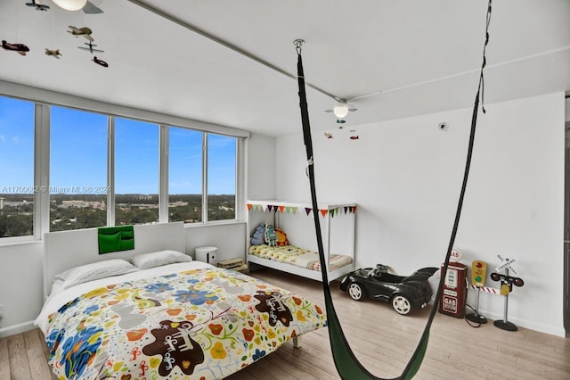 bedroom with light hardwood / wood-style floors and ceiling fan