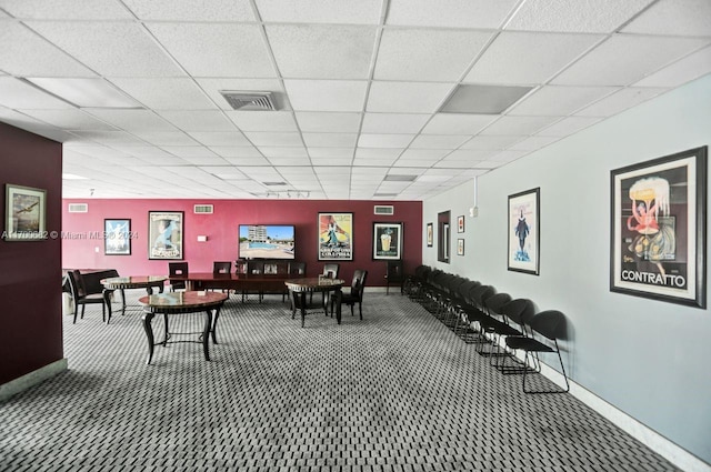 interior space with carpet and a drop ceiling