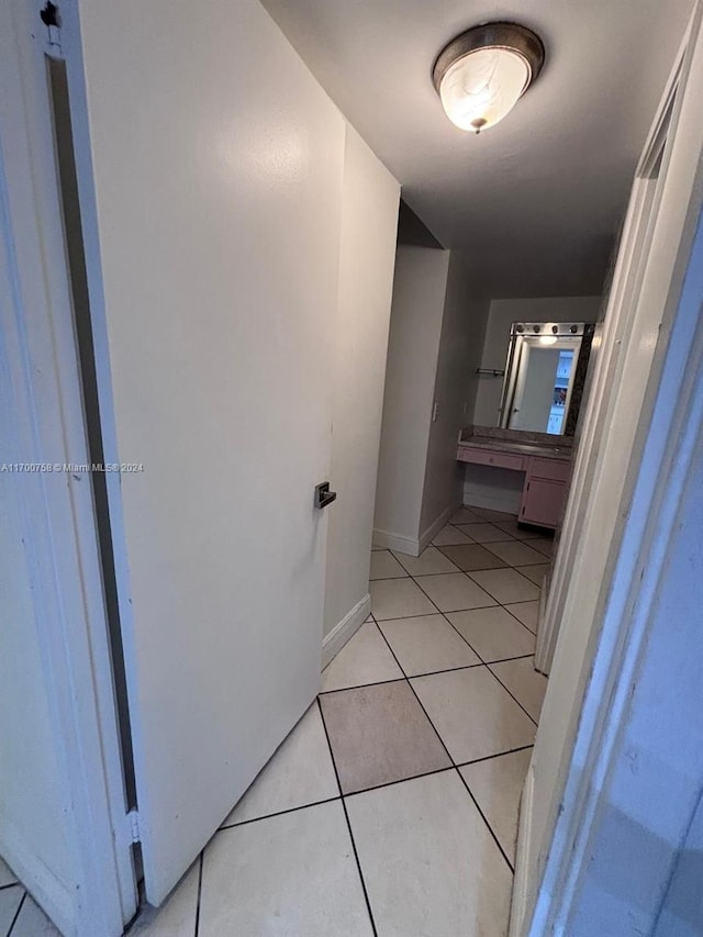 corridor featuring light tile patterned floors