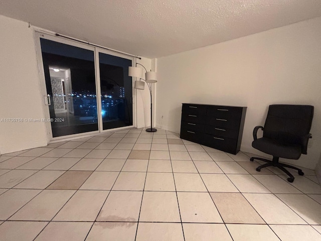 tiled spare room with a textured ceiling