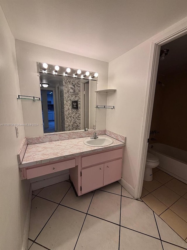 bathroom featuring tile patterned floors, vanity, and toilet