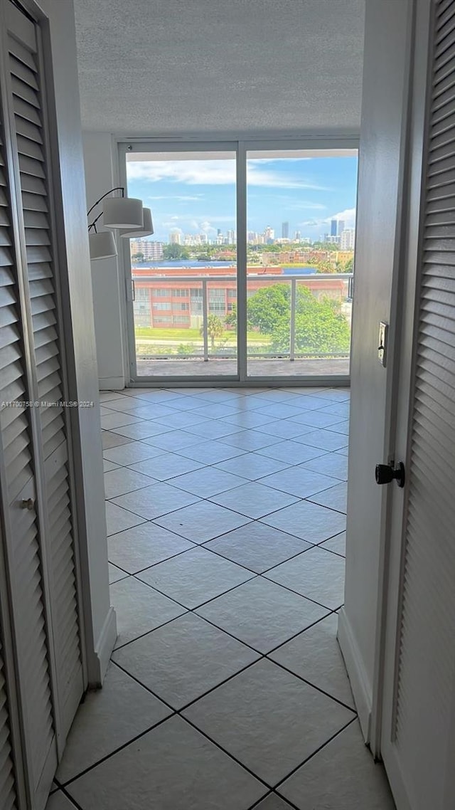 1351 NE Miami Gardens Dr Unit 604E, Miami, FL 33179 - hall with a view of city, light tile patterned flooring, and a textured ceiling
