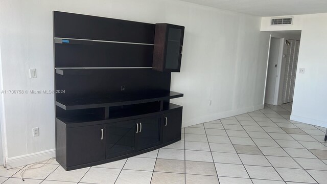 1351 NE Miami Gardens Dr Unit 604E, Miami, FL 33179 - unfurnished living room with baseboards and light tile patterned floors