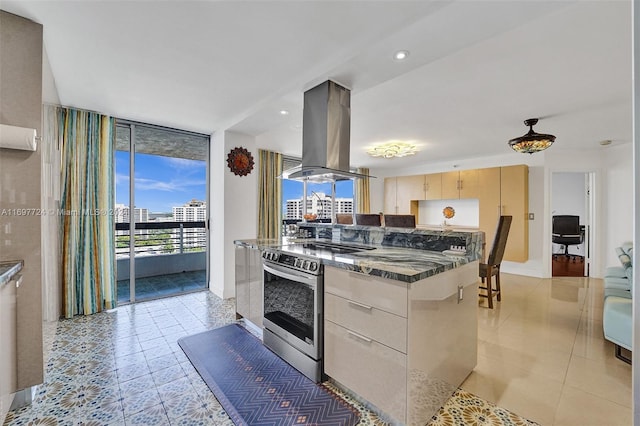 kitchen with expansive windows, light tile patterned flooring, island range hood, light brown cabinetry, and stainless steel range with electric cooktop