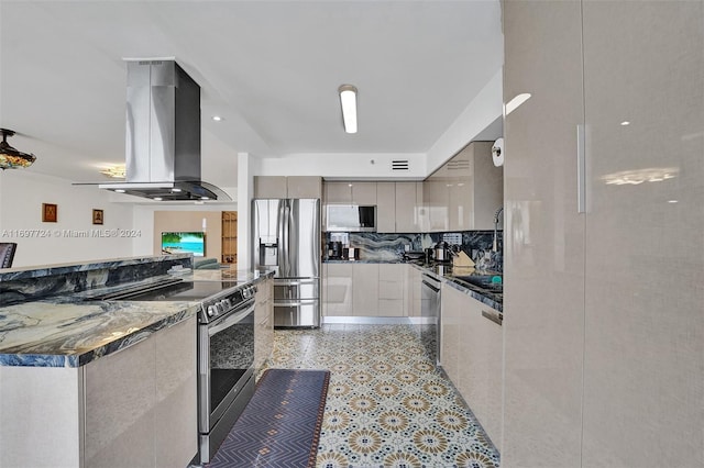 kitchen with dark stone counters, gray cabinets, extractor fan, and appliances with stainless steel finishes