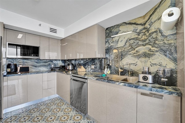 kitchen featuring appliances with stainless steel finishes, backsplash, and sink