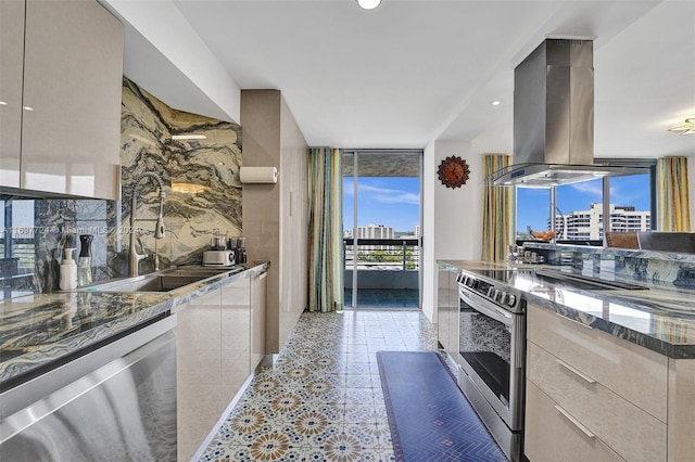 kitchen featuring expansive windows, electric stove, dark stone countertops, light tile patterned floors, and island range hood