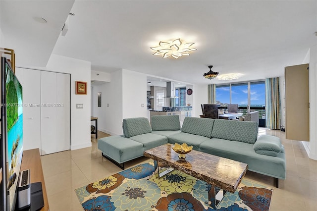 tiled living room featuring floor to ceiling windows