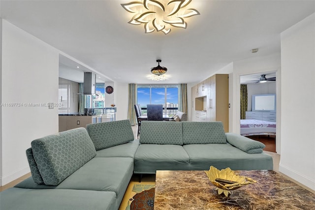 living room featuring expansive windows and ceiling fan