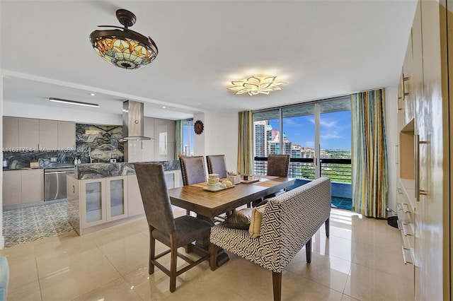 tiled dining space featuring expansive windows